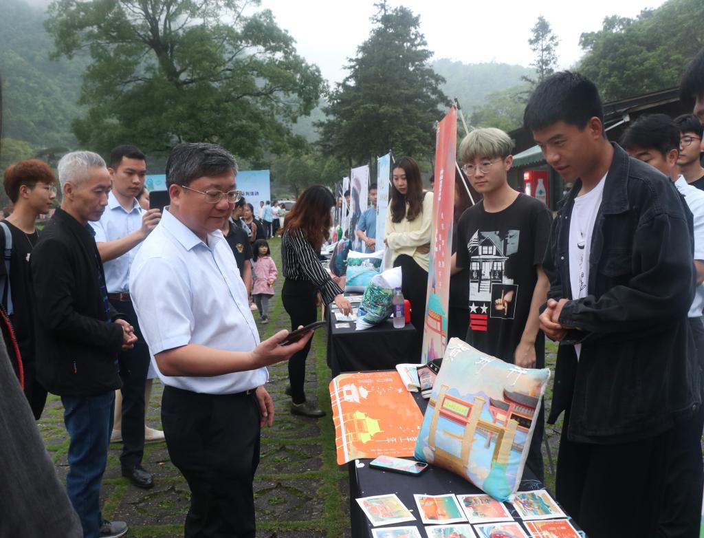 图为贺州市人民政府副市长杨育智(左二)参观3044am永利集团数字媒体艺术专业作品展览